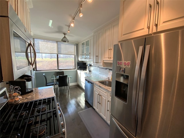 kitchen featuring light stone counters, stainless steel appliances, sink, white cabinets, and dark hardwood / wood-style floors