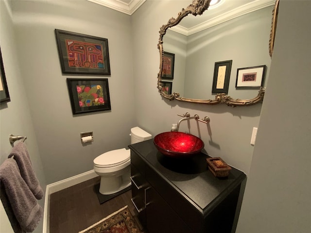 bathroom featuring crown molding, toilet, vanity, and hardwood / wood-style flooring