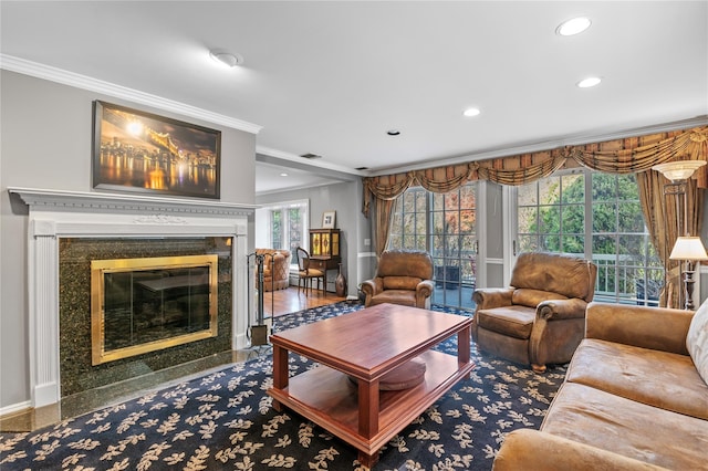 living room featuring a high end fireplace and ornamental molding