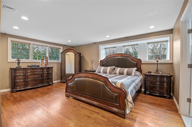 bedroom featuring multiple windows and light wood-type flooring