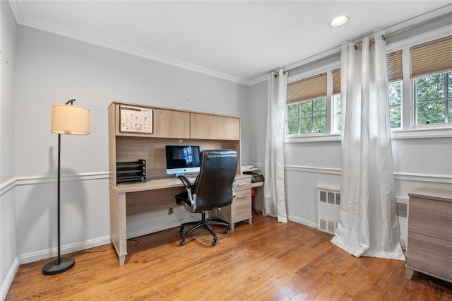 office with light wood-type flooring, crown molding, and radiator