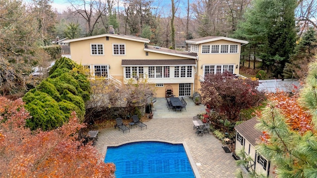 605 Bryant Ave, Roslyn Harbor, NY 11576 - rear view of house featuring a fenced in pool and a patio