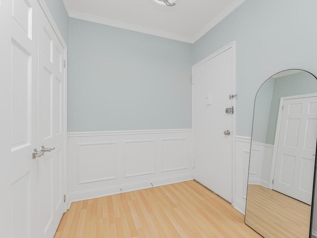 unfurnished room featuring hardwood / wood-style floors and ornamental molding