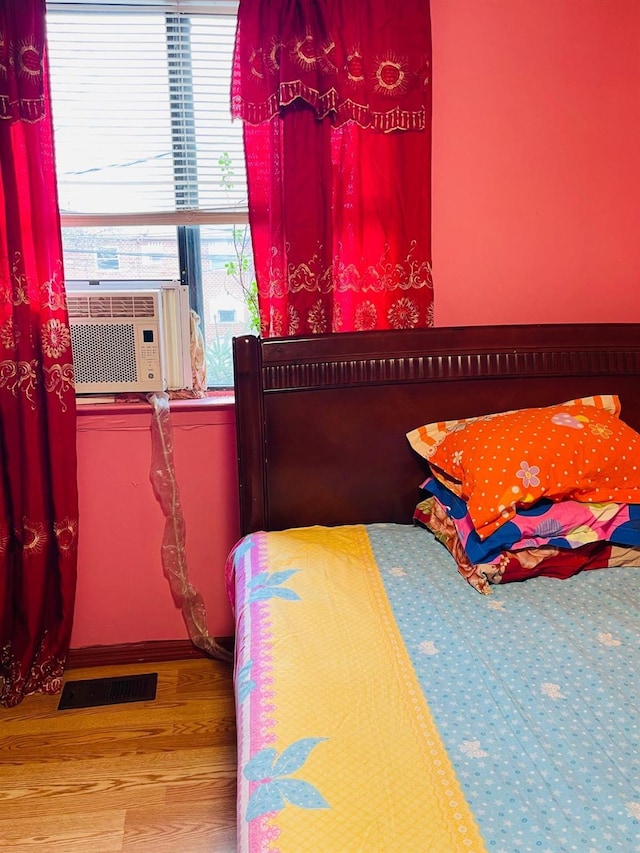 bedroom featuring cooling unit and hardwood / wood-style flooring