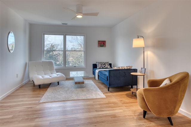 sitting room with ceiling fan and light hardwood / wood-style flooring