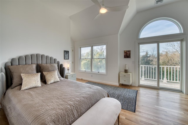 bedroom with access to outside, ceiling fan, light hardwood / wood-style flooring, and high vaulted ceiling