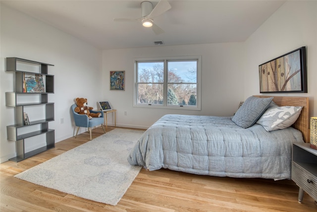 bedroom with hardwood / wood-style flooring and ceiling fan