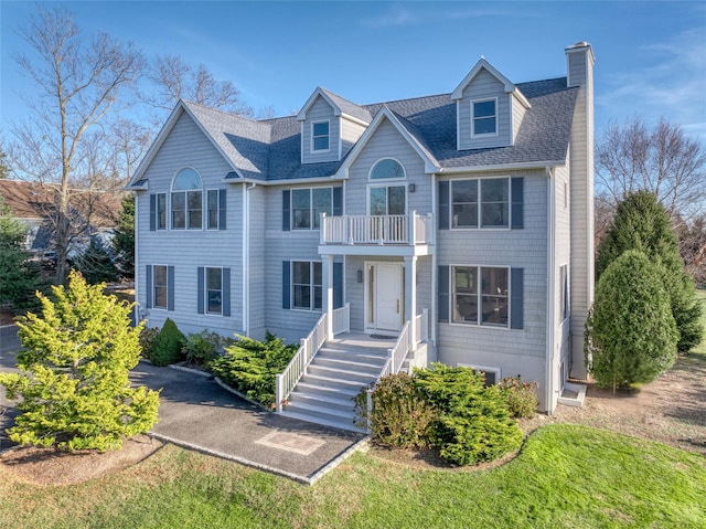 465 Sound Shore Rd, Aquebogue, NY 11901 - view of front of property featuring a balcony, a chimney, and a shingled roof