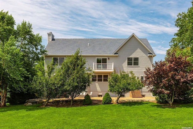 465 Sound Shore Rd, Aquebogue, NY 11901 - back of property with a balcony, a chimney, a lawn, and a shingled roof