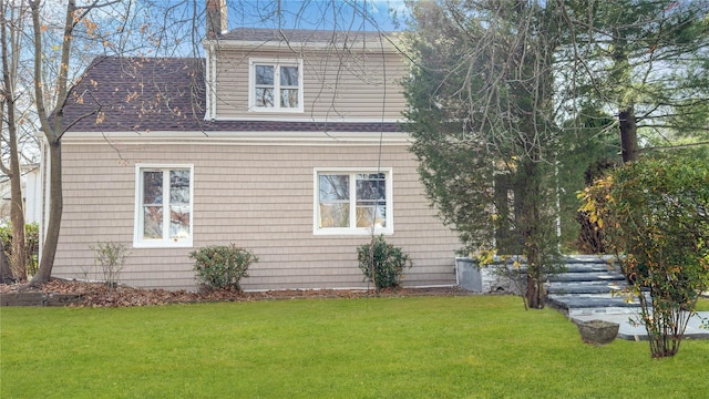 view of side of home with a yard