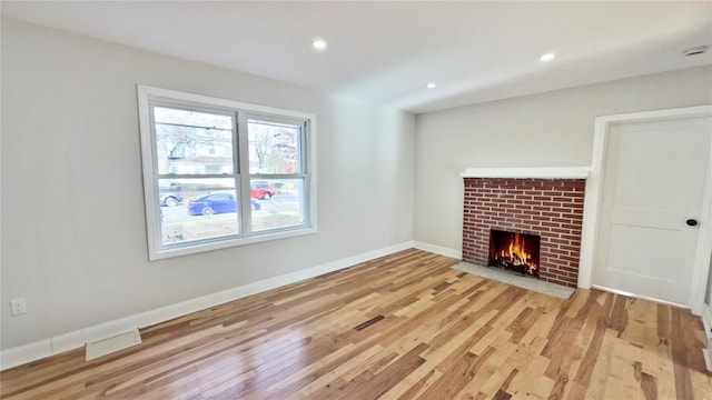 unfurnished living room featuring light hardwood / wood-style floors and a fireplace