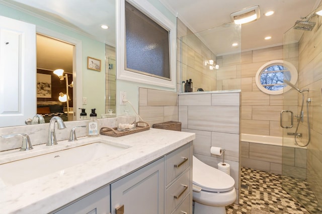 bathroom featuring an enclosed shower, vanity, crown molding, tile walls, and toilet