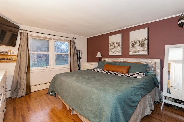 bedroom featuring wood-type flooring, a baseboard radiator, and ornamental molding