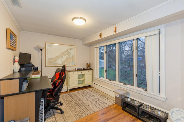 office space featuring light hardwood / wood-style flooring, baseboard heating, and crown molding