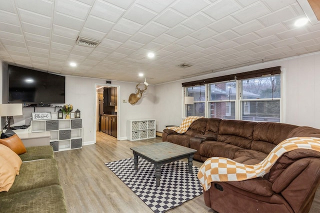 living room featuring baseboard heating and light wood-type flooring