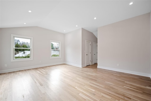 empty room featuring light hardwood / wood-style flooring and vaulted ceiling