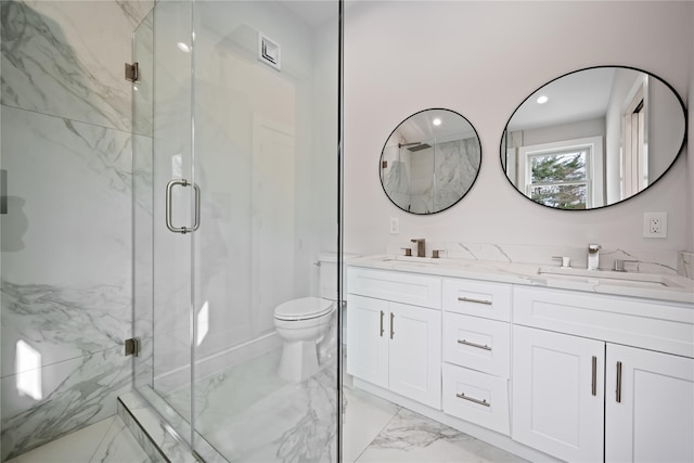 bathroom featuring vanity, toilet, and an enclosed shower