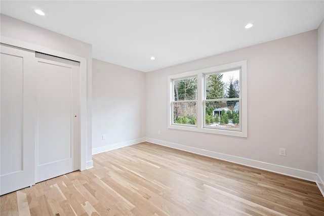 unfurnished bedroom with light hardwood / wood-style floors and a closet