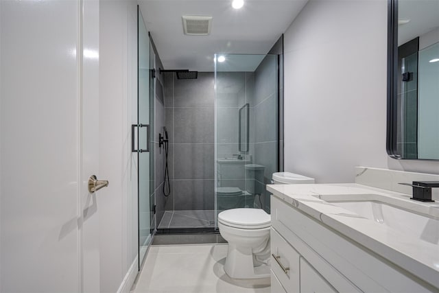 bathroom with tile patterned floors, vanity, toilet, and a shower with shower door