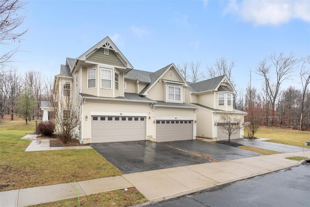 view of front of property with a front yard and a garage