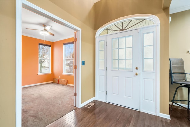 foyer featuring dark hardwood / wood-style floors, ceiling fan, and crown molding