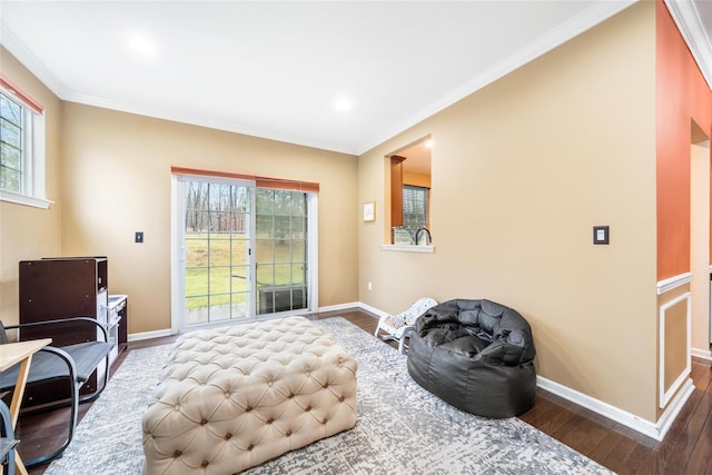 sitting room with dark hardwood / wood-style floors and ornamental molding