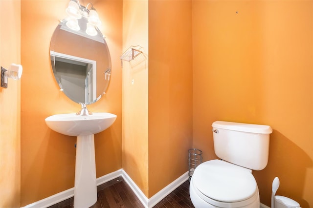 bathroom with hardwood / wood-style floors and toilet