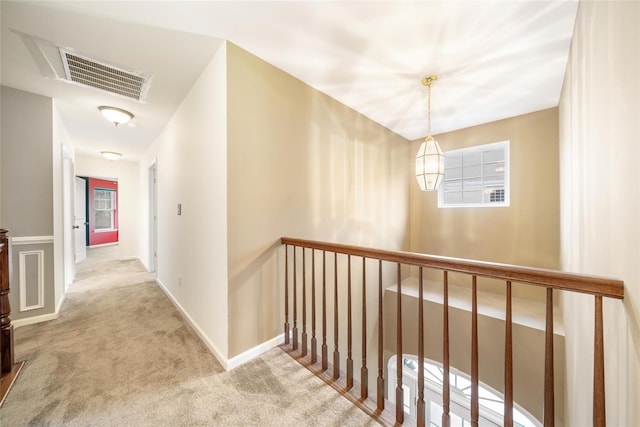 hall featuring light colored carpet