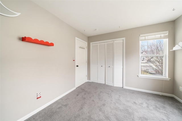 unfurnished bedroom with a closet and carpet