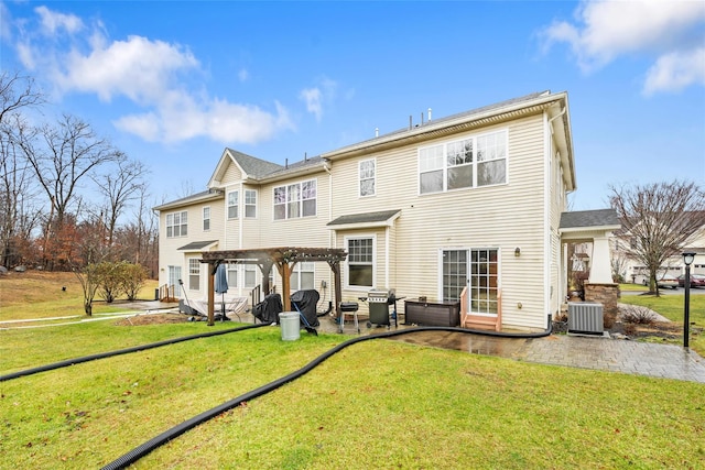 back of house featuring a pergola, a lawn, cooling unit, and a patio