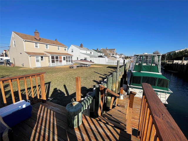 dock area featuring a water view and a lawn