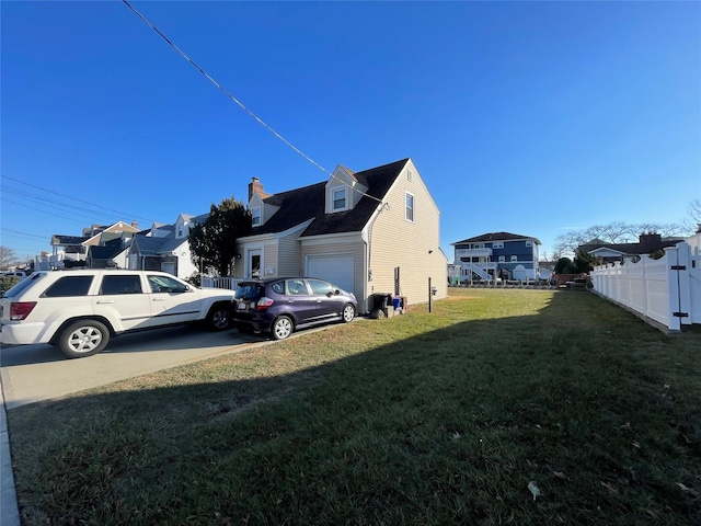 view of property exterior with a yard and a garage