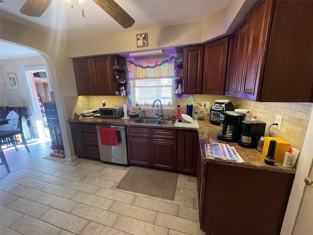 kitchen featuring dishwasher, sink, ceiling fan, tasteful backsplash, and light stone counters