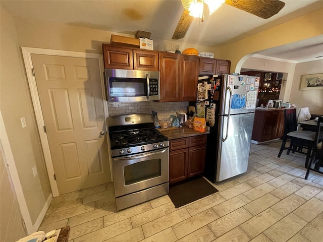 kitchen with backsplash, ceiling fan, stainless steel appliances, and light hardwood / wood-style floors