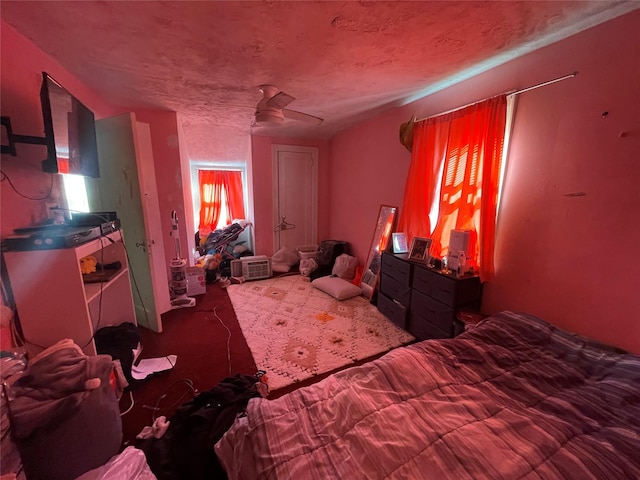 bedroom featuring carpet, a textured ceiling, and ceiling fan