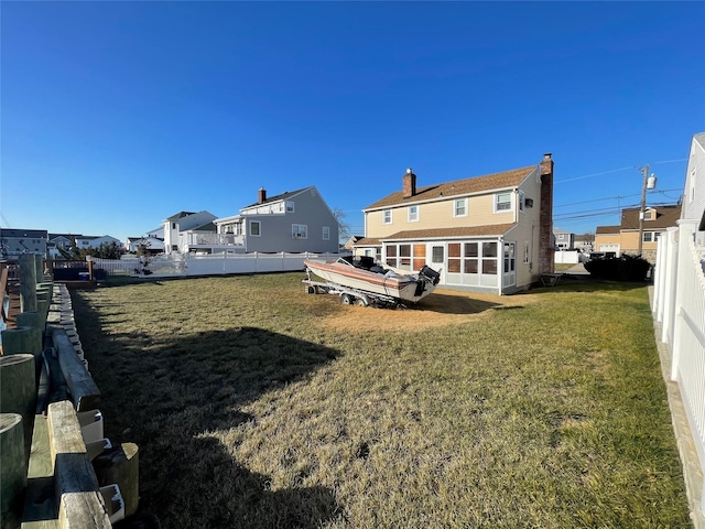 rear view of house with a lawn and a deck