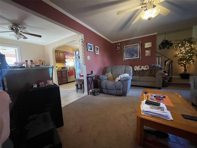 living room featuring ornamental molding, light colored carpet, and ceiling fan