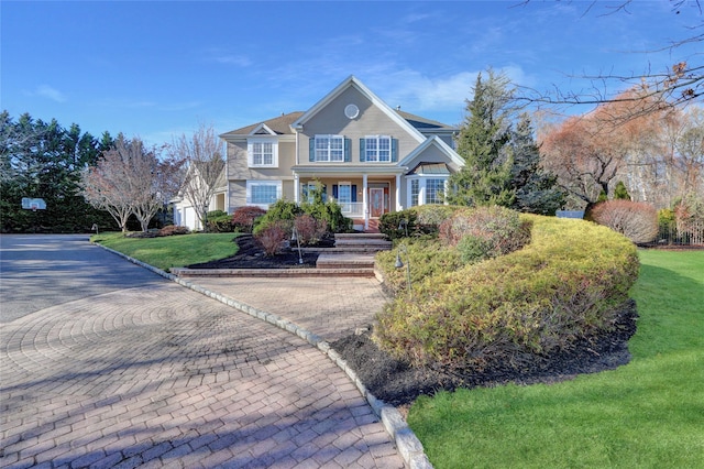 view of front of property featuring a porch and a front yard