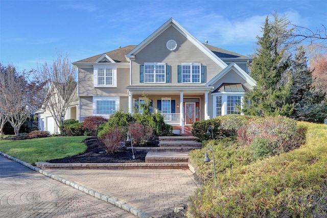 view of front of home featuring a front lawn and covered porch