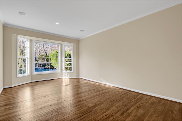 unfurnished room with wood-type flooring and crown molding