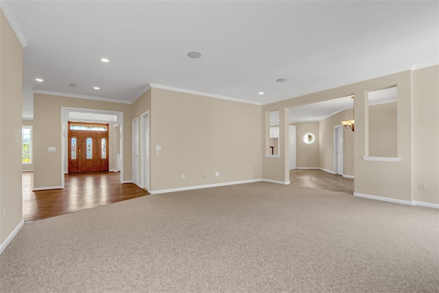 interior space with dark hardwood / wood-style floors, crown molding, and an inviting chandelier