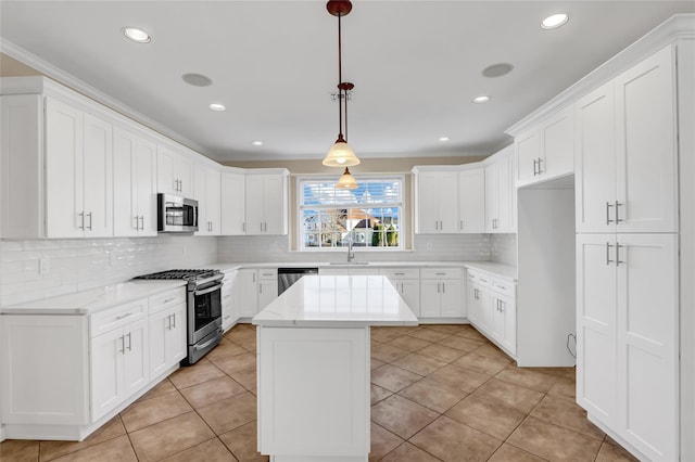 kitchen with white cabinetry, a center island, pendant lighting, and appliances with stainless steel finishes