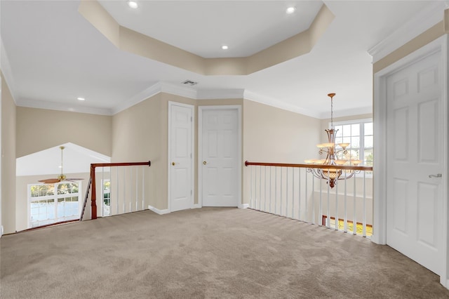 interior space featuring ceiling fan with notable chandelier, ornamental molding, and a tray ceiling