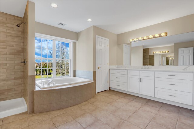 bathroom with tile patterned floors, vanity, and shower with separate bathtub