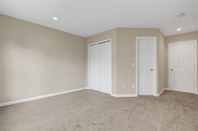 unfurnished bedroom featuring multiple closets and carpet floors