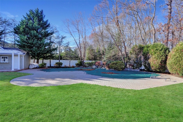 view of pool featuring a yard and a patio