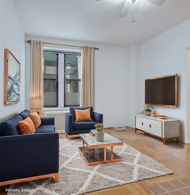 living room with ceiling fan and light wood-type flooring