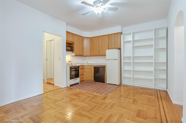 kitchen featuring sink, light parquet flooring, black appliances, and ventilation hood