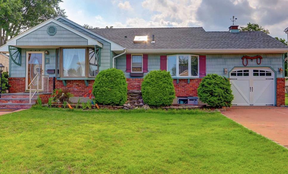 ranch-style home with a garage and a front yard