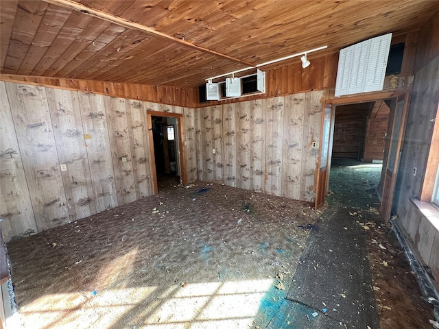 empty room with wood walls and wooden ceiling